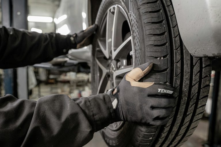 A man working on a tire in a garage